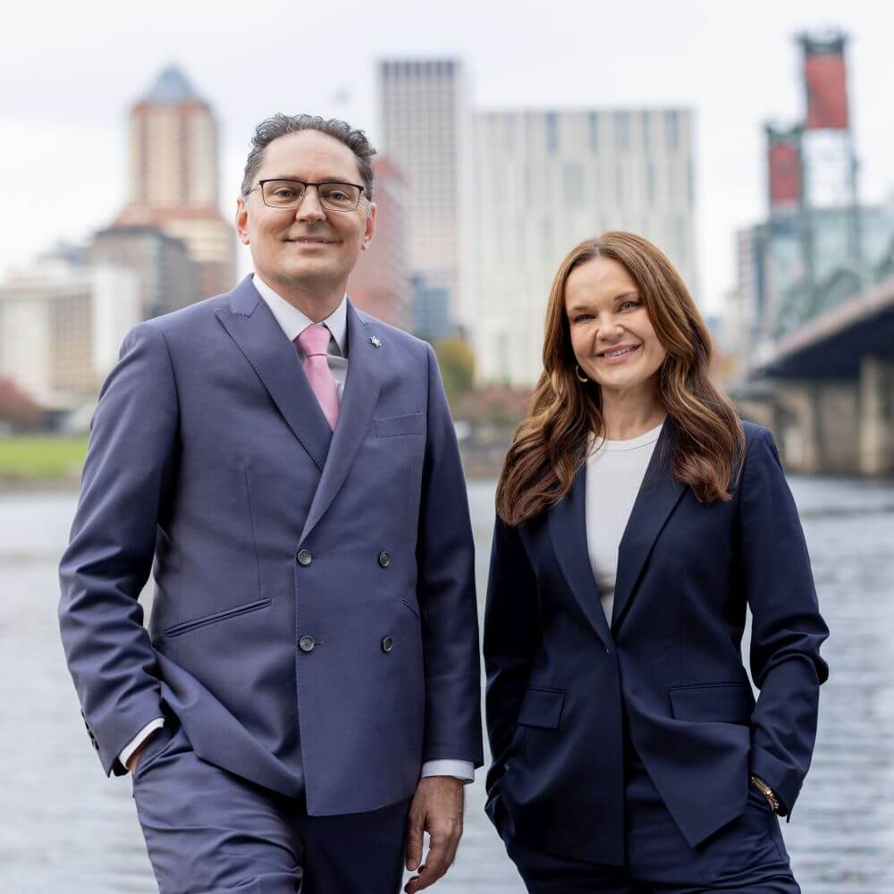 Michael Romano and Brandi Becker, Salem Oregon DUI defense attorneys, standing together outdoors.