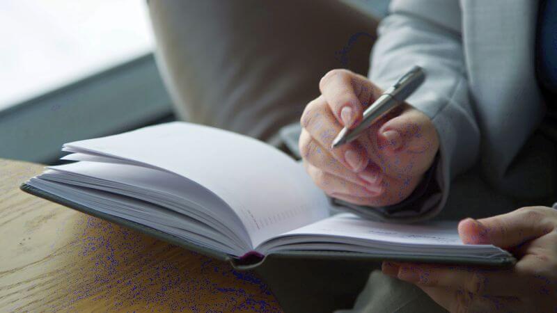 Evaluator taking handwritten notes during a brief focused assessment in an Oregon child custody case