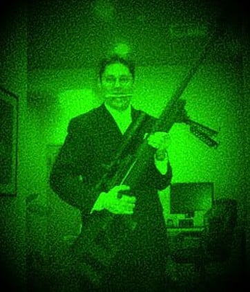 Oregon self-defense attorney Michael Romano holding a rifle, photographed through night vision