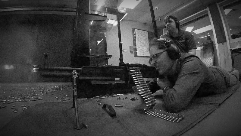 Oregon firearms attorney Michael Romano firing a belt-fed machine gun, one of the few firearms federal law requires to be registered